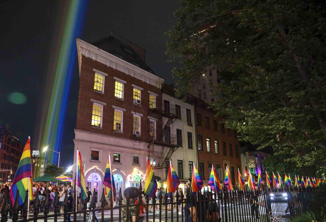 A rainbow light display illuminates the night sky near The Stonewall Inn on June 27, 2020.