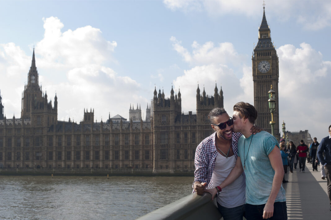 queer london A little kiss on on Westminster Bridge, with the Houses of Parliament and Big Ben in the background. Credit: Visit Britain.