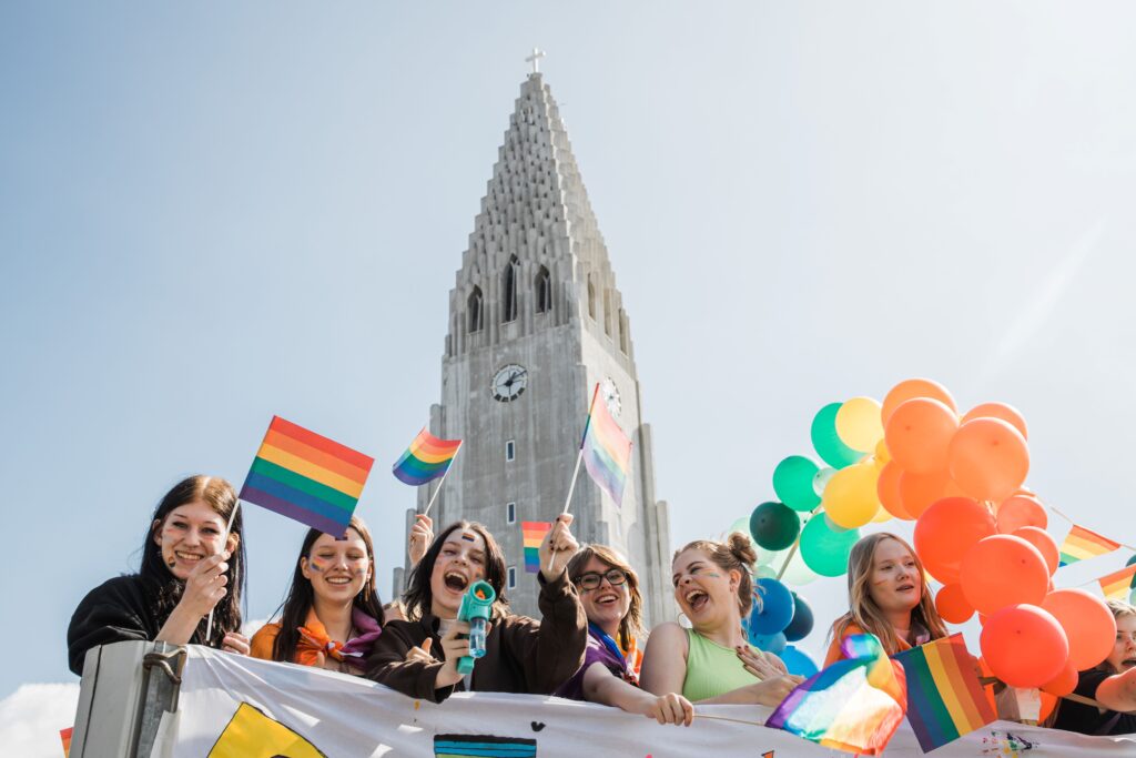 Pride participants march down a rainbow street. Credit: Visit Reykjavík